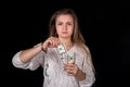 Woman with unchained handcuffs and dollar