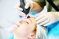 Woman under laser cosmetology procedure