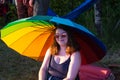 Woman under rainbow sunshade Winnipeg Folk Festival July 2019 Royalty Free Stock Photo