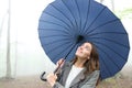 Woman under umbrella looking the rain in a park Royalty Free Stock Photo