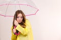 Woman under umbrella looking sad unhappy