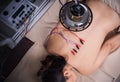 Woman undergoing acupuncture treatment with electrical stimulator on back Royalty Free Stock Photo