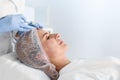 Woman undergoing face biorevitalization procedure in salon.