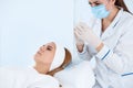 Woman undergoing face biorevitalization procedure in salon. Royalty Free Stock Photo