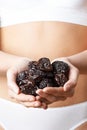 Close Up Of Woman In Underwear Holding Dried Prunes