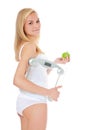 Woman in underwear holding personal scale