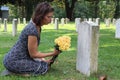 Woman at Unknown soldier`s grave with yellow flowers. Royalty Free Stock Photo