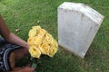 Woman at Unknown soldier`s grave with yellow flowers. Royalty Free Stock Photo