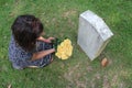 Woman at Unknown soldier`s grave with yellow flowers. Royalty Free Stock Photo