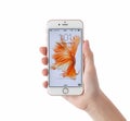 Woman unlock iPhone 6S Rose Gold on the white background