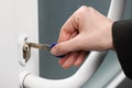 Woman unlocking door with key, closeup view