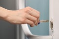 Woman unlocking door with key, closeup view Royalty Free Stock Photo