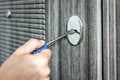 Woman unlocking door with key, closeup view Royalty Free Stock Photo