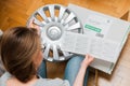 Woman unpacking car hub covers reading instruction