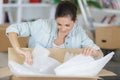 woman unpacking cardboard box