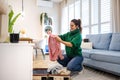 Woman unpacking her clothes in a rented apartment