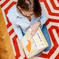 Woman unpacking parcel from Zalando fashion store