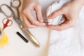 Woman unpick fabric on table