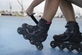 Woman unrecognizable seated tying the laces of roller skates before roller skating.Sport active lifestyle background concept Royalty Free Stock Photo