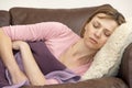 Woman Unwell And Lying On Sofa