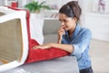 Woman upholstering chair at home