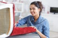 woman upholstering chair at home