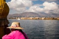 The woman from Uros community on the traditional boat made from totora reeds