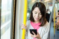 Woman use of cellphone inside train Royalty Free Stock Photo