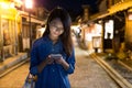 Woman use of cellphone at Kyoto night Royalty Free Stock Photo