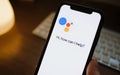 Woman use google assistant app on the iPhone.