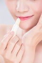 Woman use lip balm Royalty Free Stock Photo