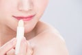 Woman use lip balm Royalty Free Stock Photo