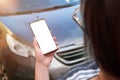 Woman use mobile phone in front of a car. Isolated screen for smart car analysis app promotion Royalty Free Stock Photo