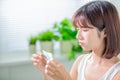 Woman use oil blotting paper