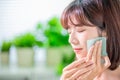 Woman use oil blotting paper