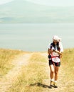 Woman use phone navigation outdoors to navigate on hiking trail to reach destination in caucasus mountains