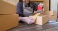 Woman use scotch tape to attach parcel boxes to prepare goods for the process of packaging, shipping, online sale