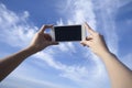 Woman use smart phone take a photo of blue sky and beautiful cloud , isolate black monitor