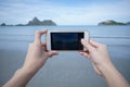 Woman use smart phone take a photo of the sea in PrachuapkhirikhWoman use smart phone take a photo of the sea in Royalty Free Stock Photo