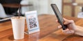 Woman use smartphone to scan QR code for order menu in cafe restaurant with a digital delivery. Choose menu and order accumulate