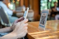 woman use smartphone to scan QR code to pay in cafe restaurant with a digital payment without cash. Choose menu and order