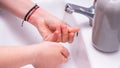 Woman use soap and washing hands under the water tap. Hygiene concept hand detail Royalty Free Stock Photo