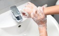 Woman use soap and washing hands under the water tap