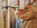 Woman used Hand Sanitizer, gel alcoholic mixture with gelatin in clear Plastic bottle with pump pushing wash clean dirty to