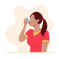 Woman uses an asthma inhaler against an allergic attack Royalty Free Stock Photo