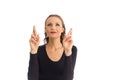 Woman uses both hands to cross her fingers. She has green eyes. Royalty Free Stock Photo