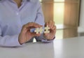 A woman uses both hands to try to connect the two jigsaw puzzles together. symbol of association and connection. support and help Royalty Free Stock Photo