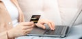 woman uses a credit card to pay for goods after shopping online through a socially marketed merchant's website.
