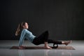 Woman uses foam roller to remove pain, stretch and massage muscles of legs. Royalty Free Stock Photo