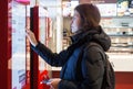 MINSK, BELARUS - november 26, 2017: Woman uses KFC kiosk to order food at KFC restaurant